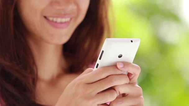 Woman using touchscreen phone outdoors. focus on cellphone — Stock Video