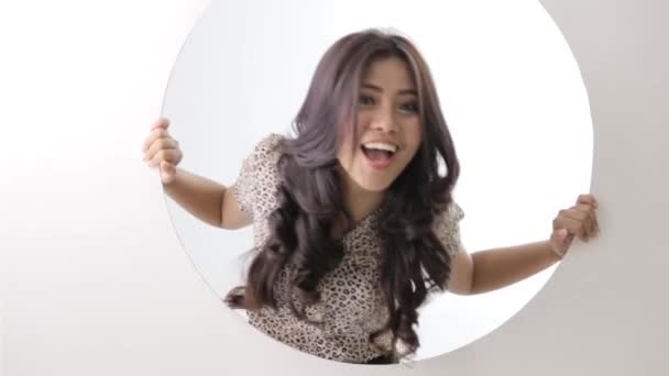 하얀 원으로 된 구멍 안에서 웃고 있는 행복 한 여성 — 비디오