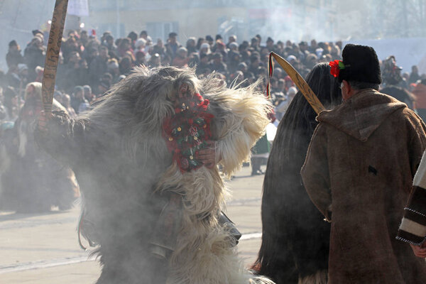 Kukeri, mummers perform rituals with costumes and big bells, intended to scare away evil spirits during the international festival  of masquerade games Surva in Pernik, Bulgaria  Jan27,2018. Folklore ensemble. 