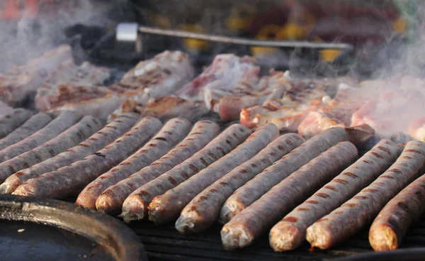 Pile of homemade raw sausages. Hot dog sausages prepared for grill. Fast food outside.