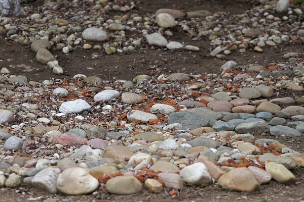 Stones background texture. Installation from rocks, stones and pebbles. Selective focus. Rocks texture. Color stones. Pieces of bricks