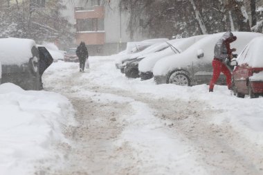 Kış. İnsanlar bir çok karlı kaldırım ve yol üzerinde yürümek. İnsanlar adım buzlu bir yolu üzerinde buzlu kaldırım. Kaplarda caddeler ve yollar. 