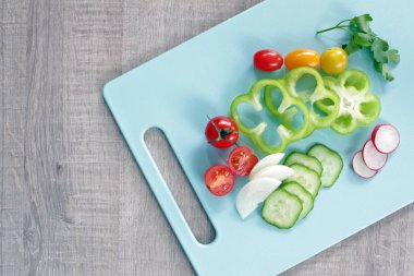 Colorful vegetables on cutting board with copy space