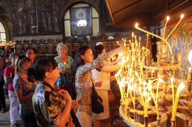 People light candles in St. Sedmochislenitsi church during a big