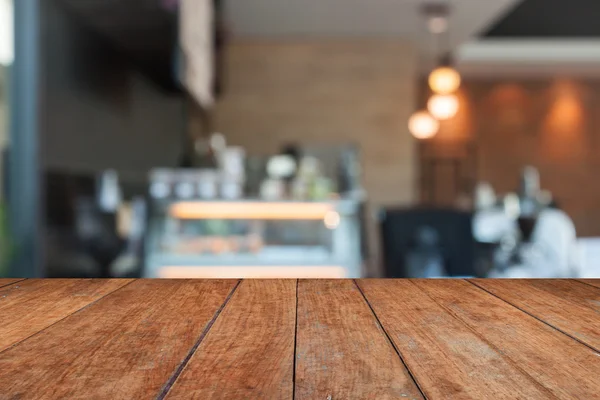 Perspectiva de madera marrón con cafetería borrosa — Foto de Stock