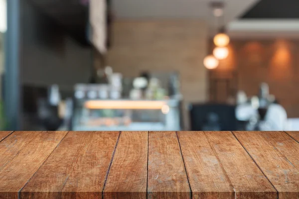 Perspektivy top hnědá dřevěná s rozmazané coffee shop — Stock fotografie
