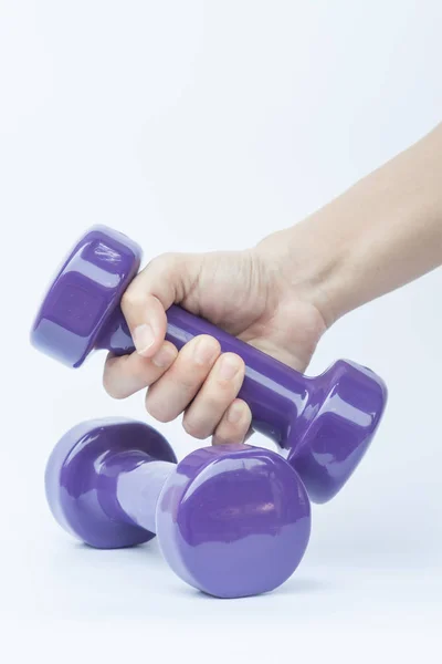 Woman hand holding dumbbell weight isolated on white background — Stock Photo, Image