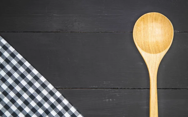 Wooden spoon with tablecloth — Stock Photo, Image