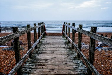 wooden pathway on Worthing beach clipart
