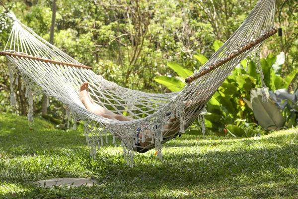 Girl resting in a cozy hammock in a tropical garden on the island of Bali, Indonesia — Stock Photo, Image