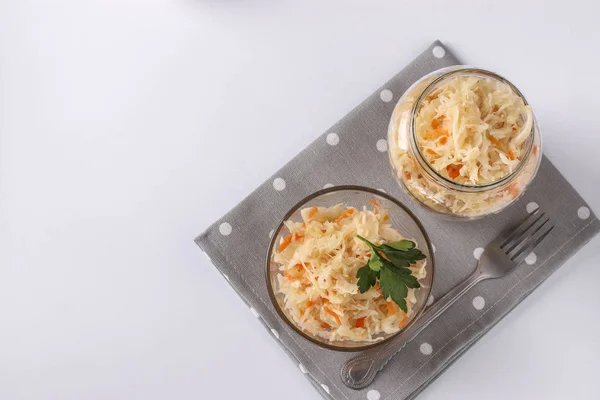Fermented food, Homemade Sauerkraut with carrots in a bowl and jar on white background, Top view