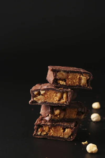 Italian chocolate with biscuit and nuts on a black background, Closeup