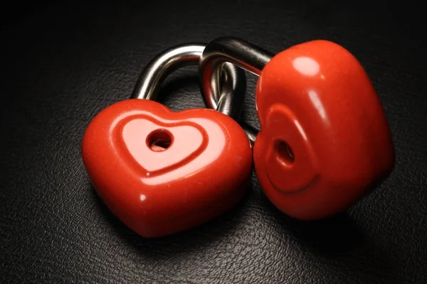 Red heart locks on black background