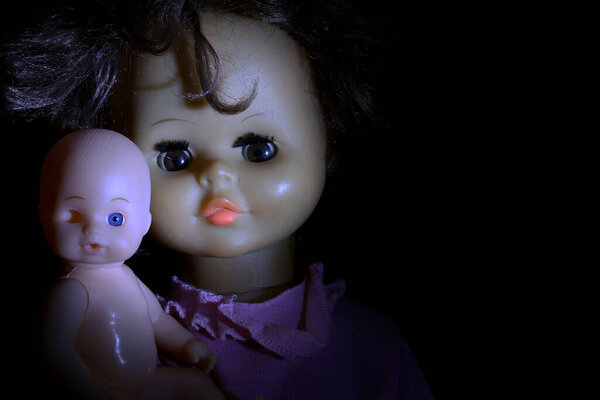 Old dolls on dark background