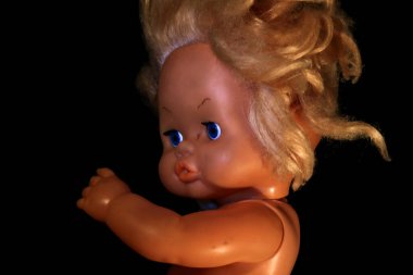 Esmer arka planda eski oyuncak bebek