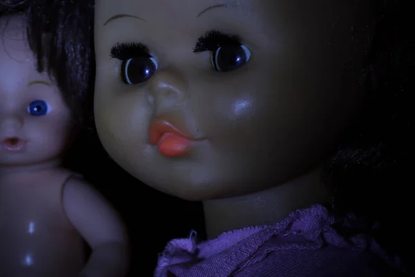 Old dolls on dark background