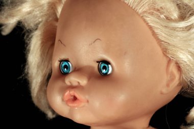 Esmer arka planda eski oyuncak bebek