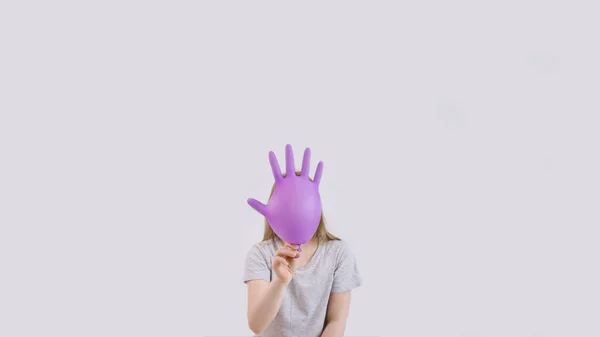 Young kid play with purple protective medical glove — Stock Photo, Image