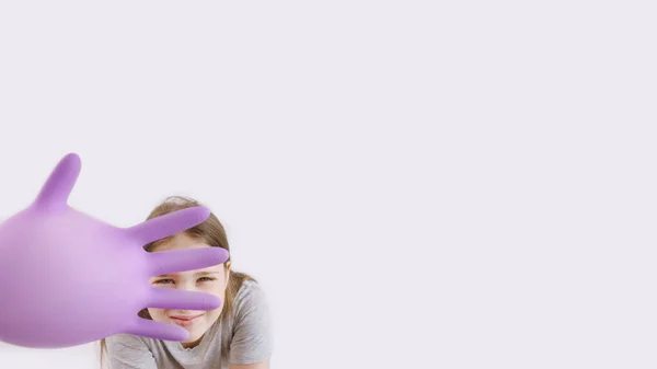 Young kid play with purple protective medical glove — Stock Photo, Image