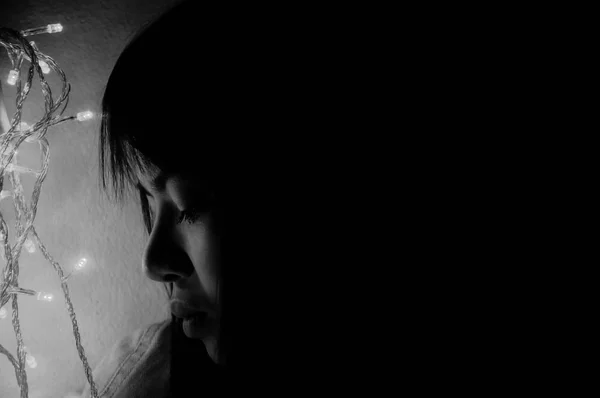 Sad and broken heart female profile silhouette in dark, monochrome image with copy space