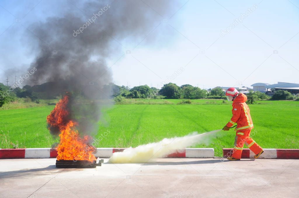 Instructor showing how to use a fire extinguisher on fire fighting training