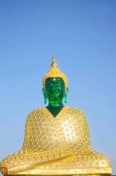 Emerald Buddha with clothes for winter season — Stock Photo, Image