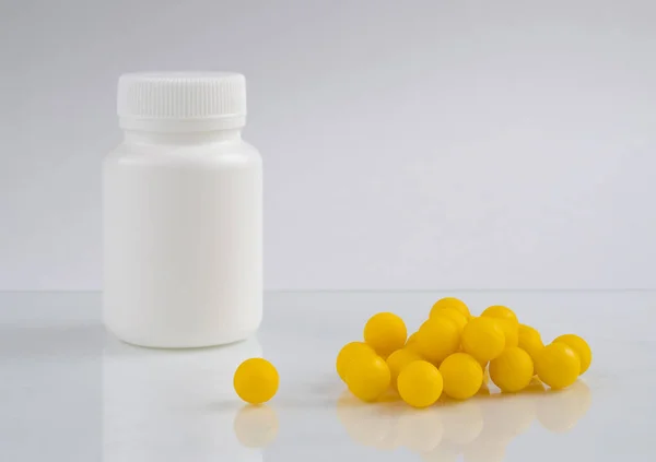 White Plastic Bottle Medicine Standing Next Yellow Pills White Background — Stock Photo, Image