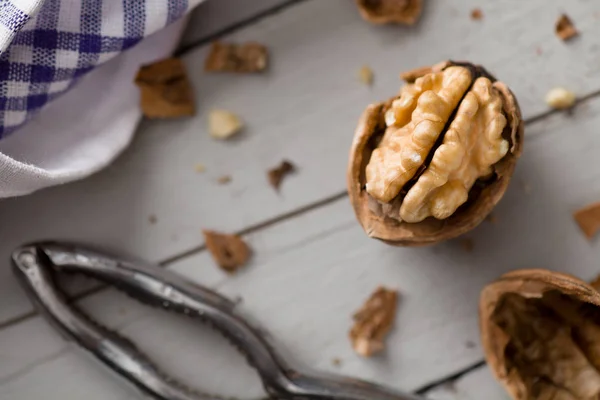 Cracked Walnut with Nutcracker — Stock Photo, Image