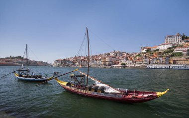 Porto şehrinin önündeki tarihi şarap tekneleri güneşli bir günde Douro nehri, nehir kenarında evler, Portekiz