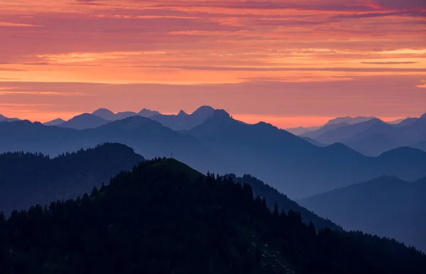 Mountain silhouettes layers of the Bavarian Alps during sunrise from Jochberg Walchensee, Bavaria Germany