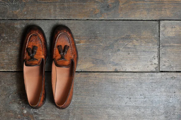 leather handmade shoes on a wooden background