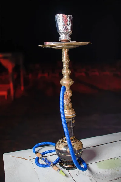 dark high hookah in the institution on a dark background