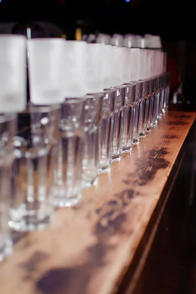 empty glasses on a wooden bar counter