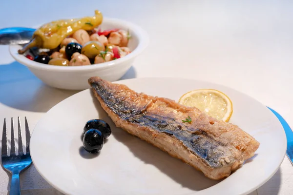 Fried mackerel on white plate and salad — Stock Photo, Image