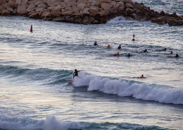 Surfer  on red board ride the wave — Stok fotoğraf