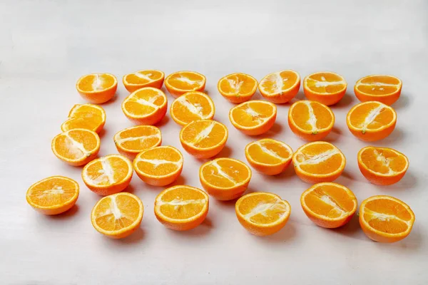 juicy halves of oranges on a brown wooden table  . Vitamin C and healthy vegan food