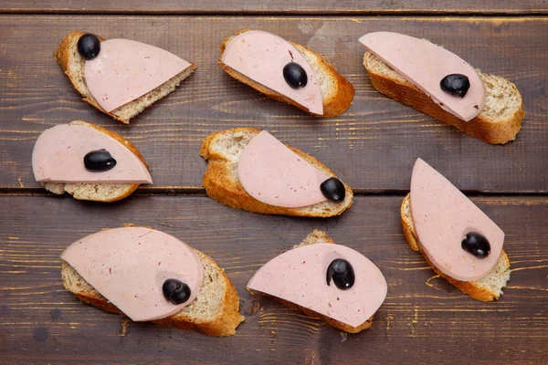 sandwich with Lyon sausage and a slice of black olive
