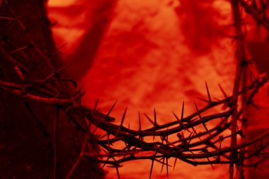 blood red crown of thorns up close with old wooden beam on cloth clipart