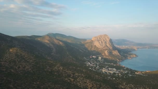 Aerial shot of amazing mountains and rocks on a seashore. Karaul-oba Mountain in Crimea. — Stock Video