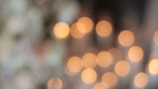 Glare from sparks of candles in the church. The lights flicker in a vintage style, and the flicker of the lights conveys a festive mood. Beautiful radiance for holiday stories. Blurry glare of light. — 비디오