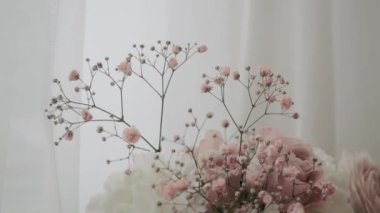 Set of burgundy wedding roses for a wedding evening. Beautiful flowers for bride and groom, close-up view. A lot of fresh flowers for the wedding ceremony and party. Bright jewelry and accessories.