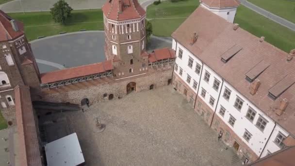 Mir Castle - an architectural masterpiece in the style of Belarusian Gothic, aerial shot. Beautiful old Belarus castle is located in the village of Mir, a top view. A must-see attraction for tourists. — Stock video