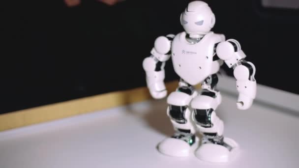 Charkov, Ukrajina - 09 Listopad 2019: Lidé se dívají, jak futuristický humanoidní hračka robot chodí. Realistické lidské pohyby robota ubtech. Koncept budoucnosti, nové technologie. — Stock video
