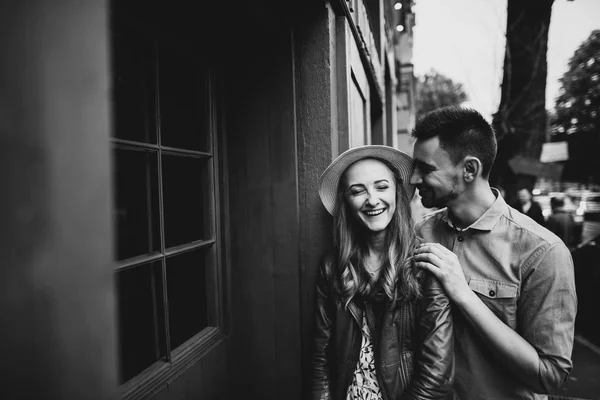 Black and white portrait of a happy loving couple outdoors. They walk around the old town. Love story