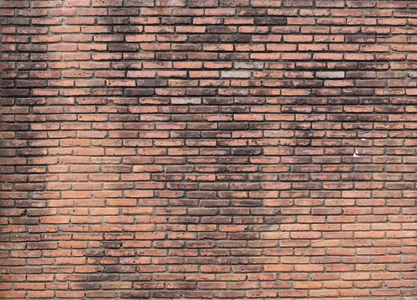 Muro de ladrillo viejo ligeramente iluminado — Foto de Stock
