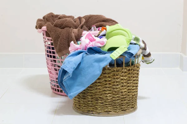 Pile of dirty laundry in a washing basket on a white background