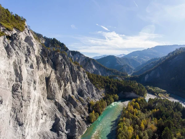 Canyon with meandering river, lined with a forest