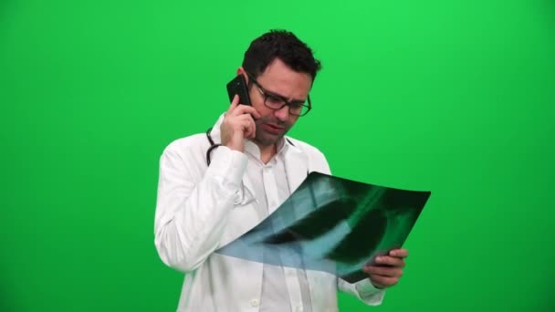 Doctor Holding Ray Results Talking Phone Green Screen — Stock Video