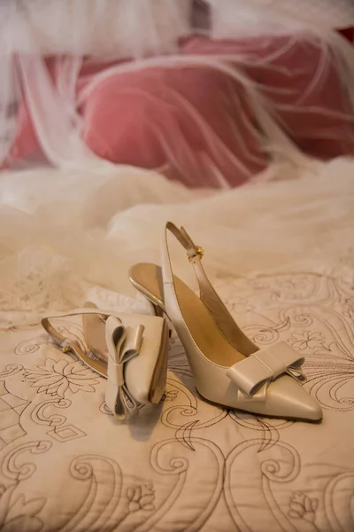 bride\'s shoes on the bed before the wedding