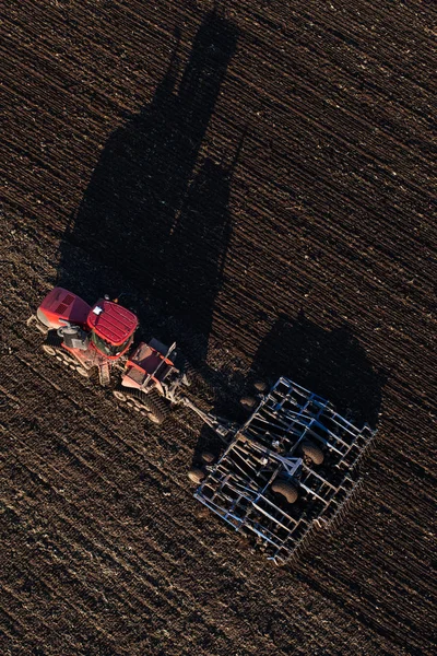 Aerial view of tractor in harvest fields — Stock Photo, Image